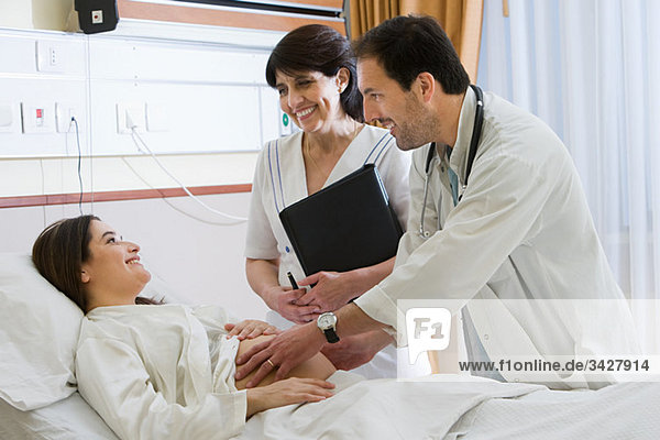Pregnant woman with doctor and nurse