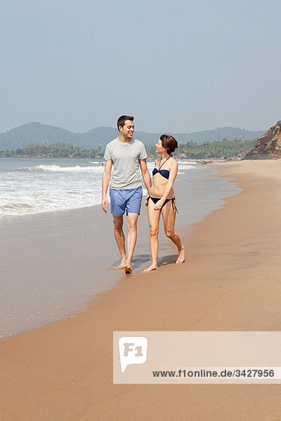 Couple walking by the ocean