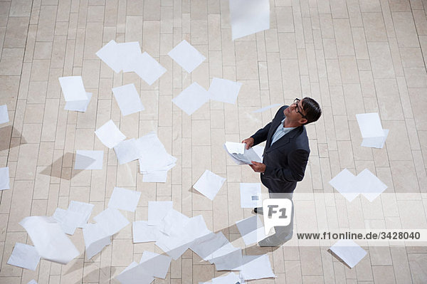 Businessman throwing papers