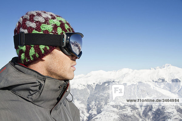 Portrait of young man with ski goggles  profile