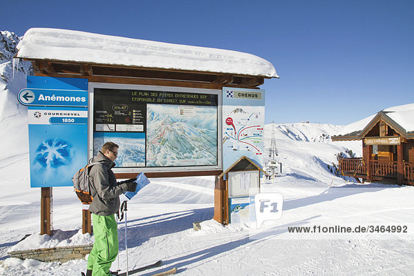 Male skier looking at map  Courchevel  France