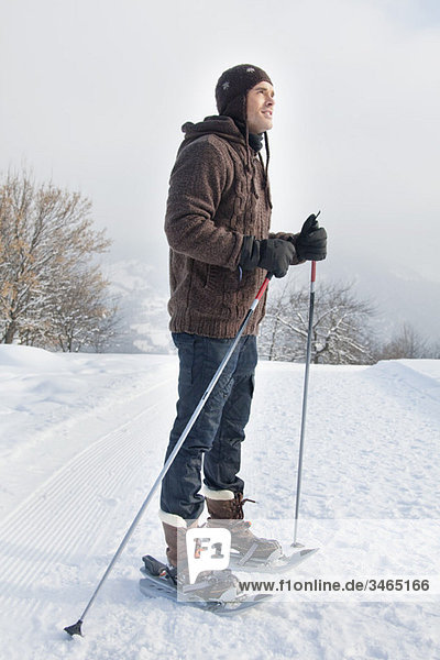 Young man wearing snowshoes
