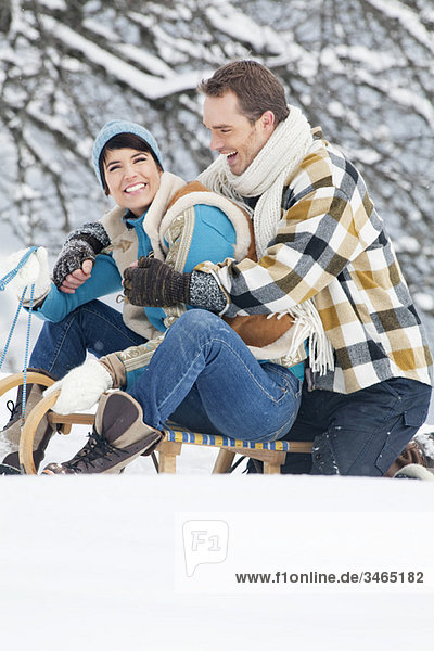 Young couple embracing on sled