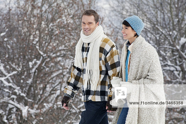 Young couple walking in snow