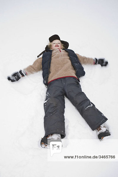A child making a snow angel