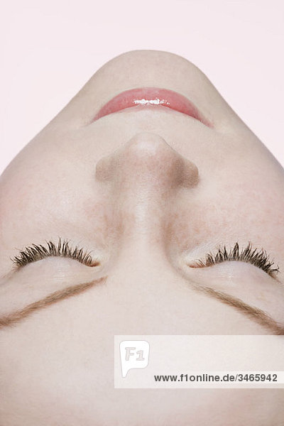 A woman with closed eyes  extreme close up  rear view  lying on back