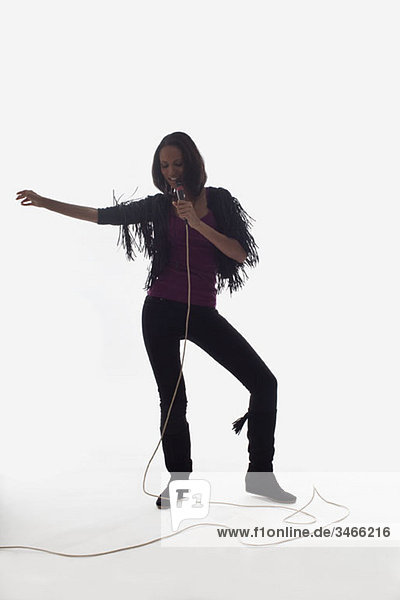 A female singer performing  studio shot  white background  back lit