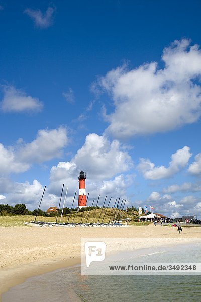 Sailing boats on a beach  lighthouse in the background  Hörnum  Sylt  Schleswig-Holstein  Germany