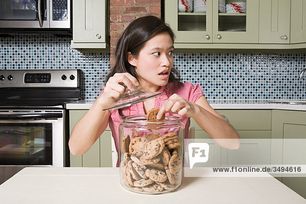 Young woman with cookie jar