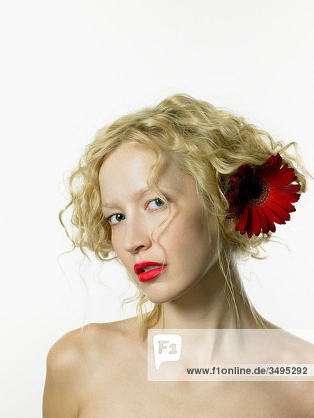 Young woman wearing red flower in hair