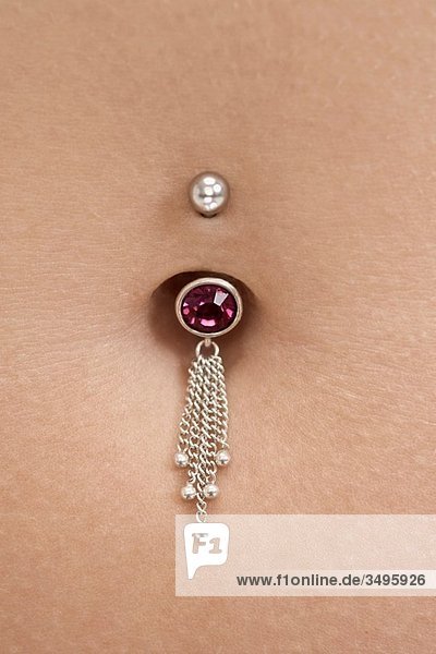 woman´s tummy pierced with jewel  detail