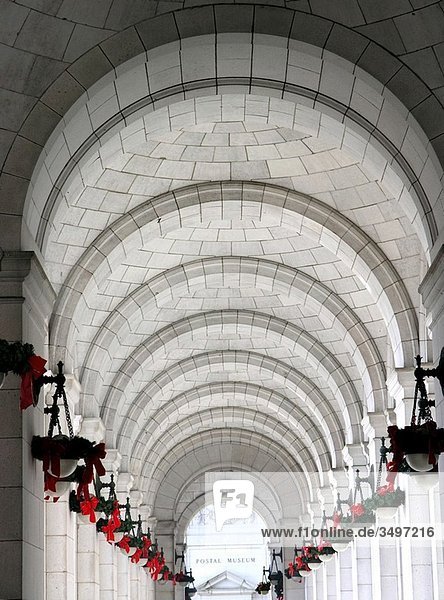 USA,  Washington D C ,  outdoor row of arches with holiday wreaths on lamps