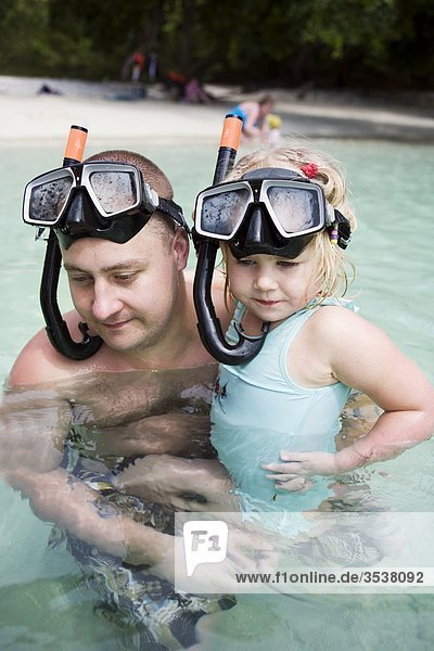 Father swimming with daughter