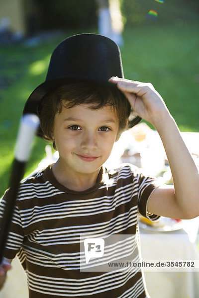 Boy with magic wand and magician's hat  portrait