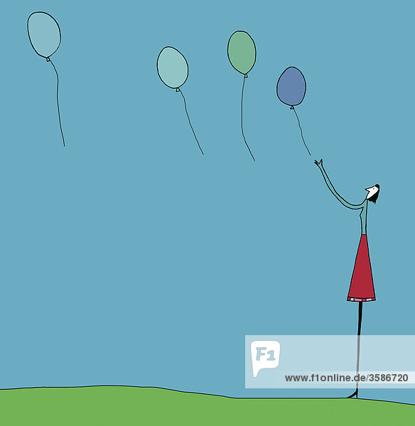Frau lässt Luftballons steigen