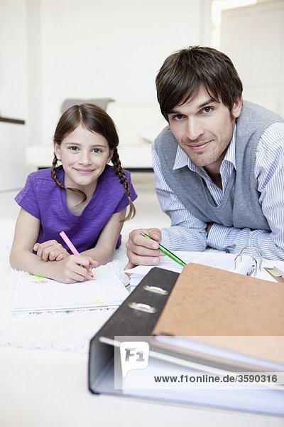 Father and girl doing paperwork