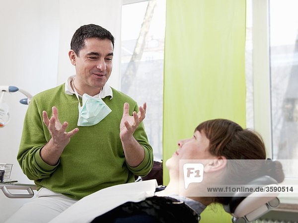 Zahnarzt erklärt den Patienten in der Chirurgie