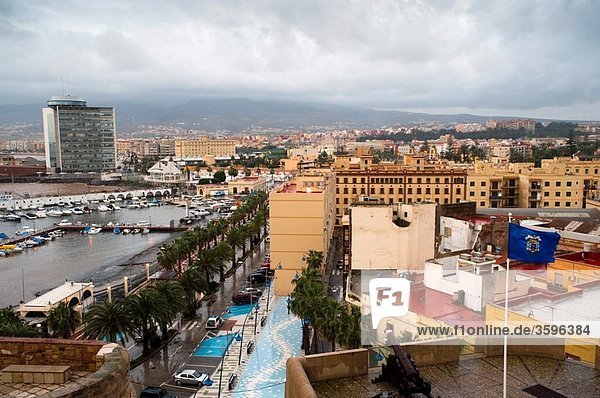 City and seaport seen from the old town with cannon and flag of Melilla  Melilla  Spain  Europe