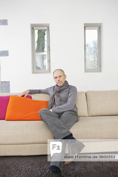 Portrait of a man sitting on a couch