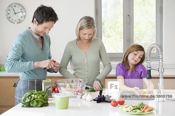 Family preparing food in the kitchen