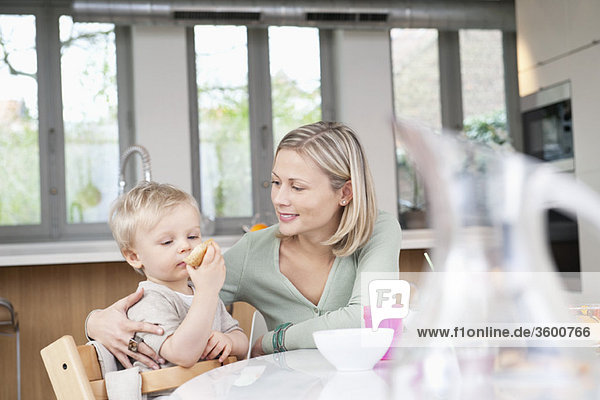 Woman eating breakfast with her son