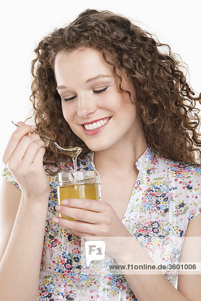 Close-up of a woman eating honey