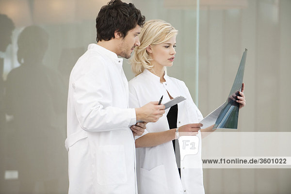 Doctors examining an x-ray report