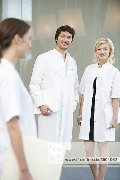 Male doctor standing with two female doctors