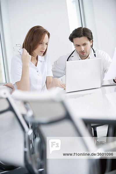 Doctors working on a laptop