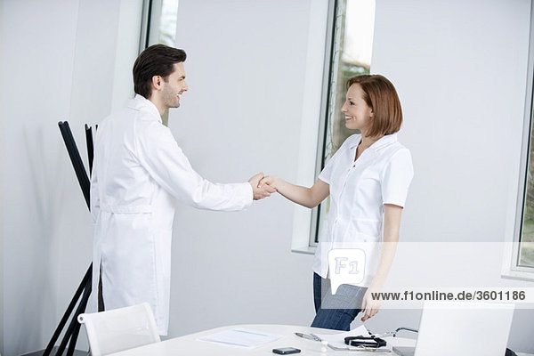 Two doctors shaking hands