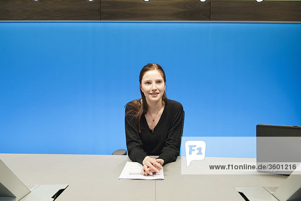 Businesswoman doing paperwork in a conference room