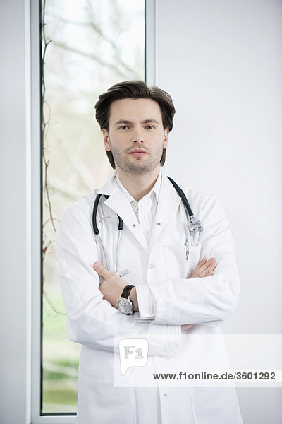 Portrait of a doctor standing with his arms crossed