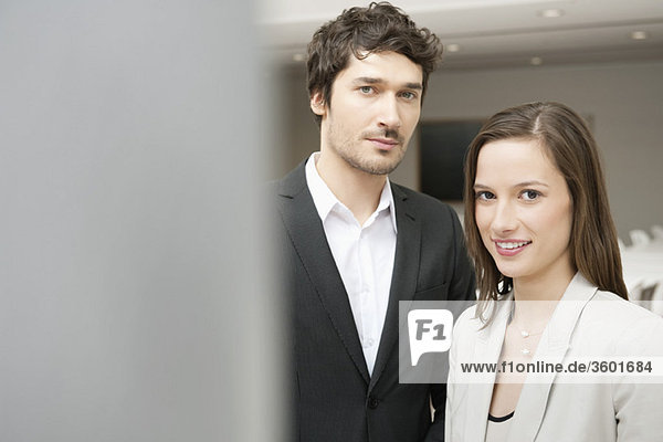 Portrait of a businesswoman smiling with her colleague beside her
