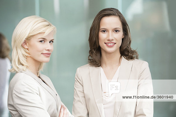 Portrait of two businesswomen smiling together