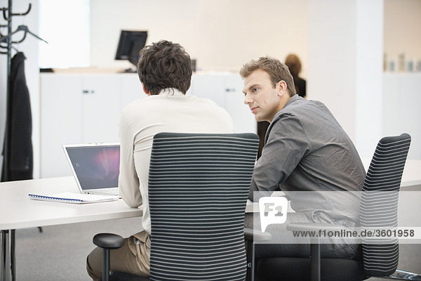 Two businessmen working in an office