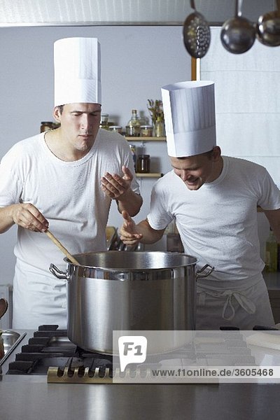 Two chefs standing by range