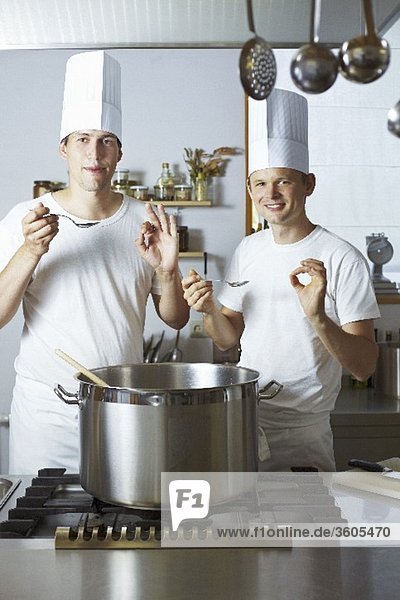 Two chefs satisfied with the results of their culinary skills