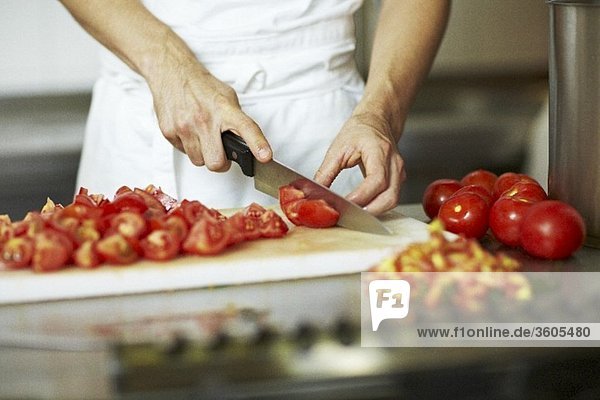 Chef chopping tomatoes