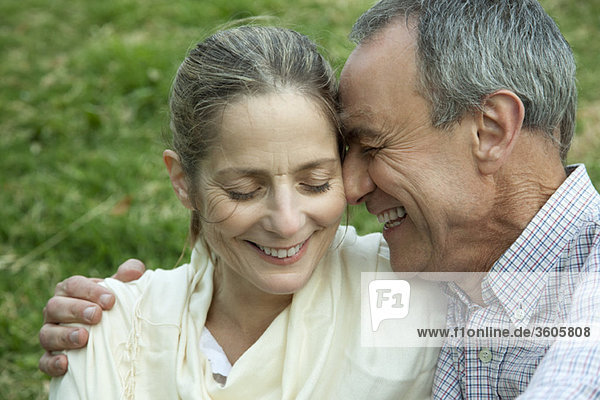 Mature couple embracing  eyes closed