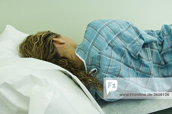 Female patient lying on side on examination table