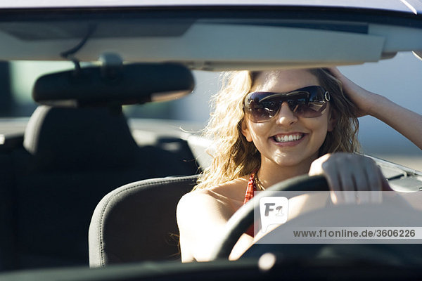 Young woman out for drive on sunny day