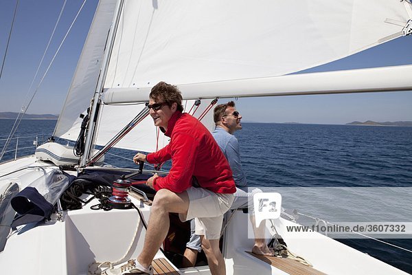 Two men setting sail on yacht
