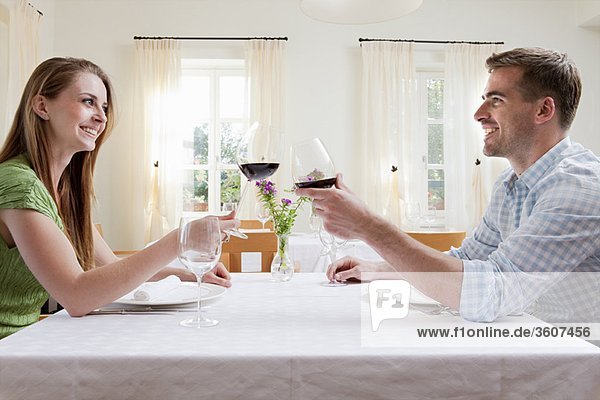 Couple at restaurant toasting with wine
