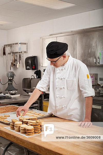 Male chef baking cookies in commercial kitchen