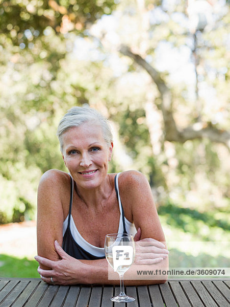 Mature woman outdoors with wine
