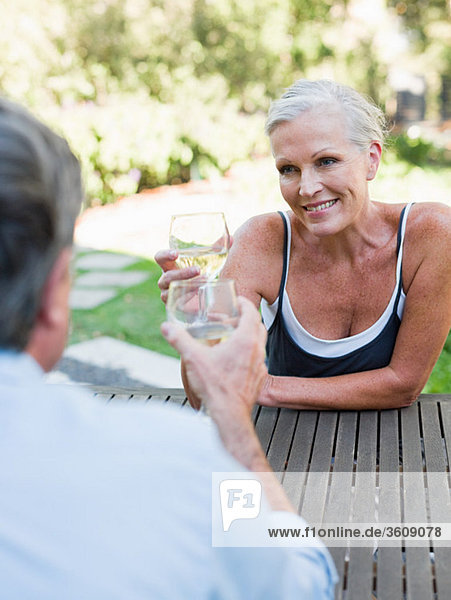 Couple toasting with wine outdoors