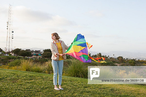 Young woman in a field with a kite