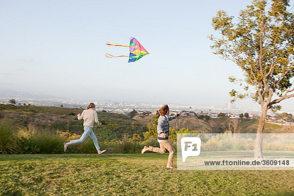 Young couple flying a kite