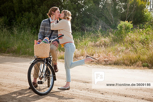 Kissing couple with bicycle