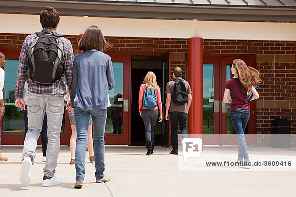 High school students entering school building